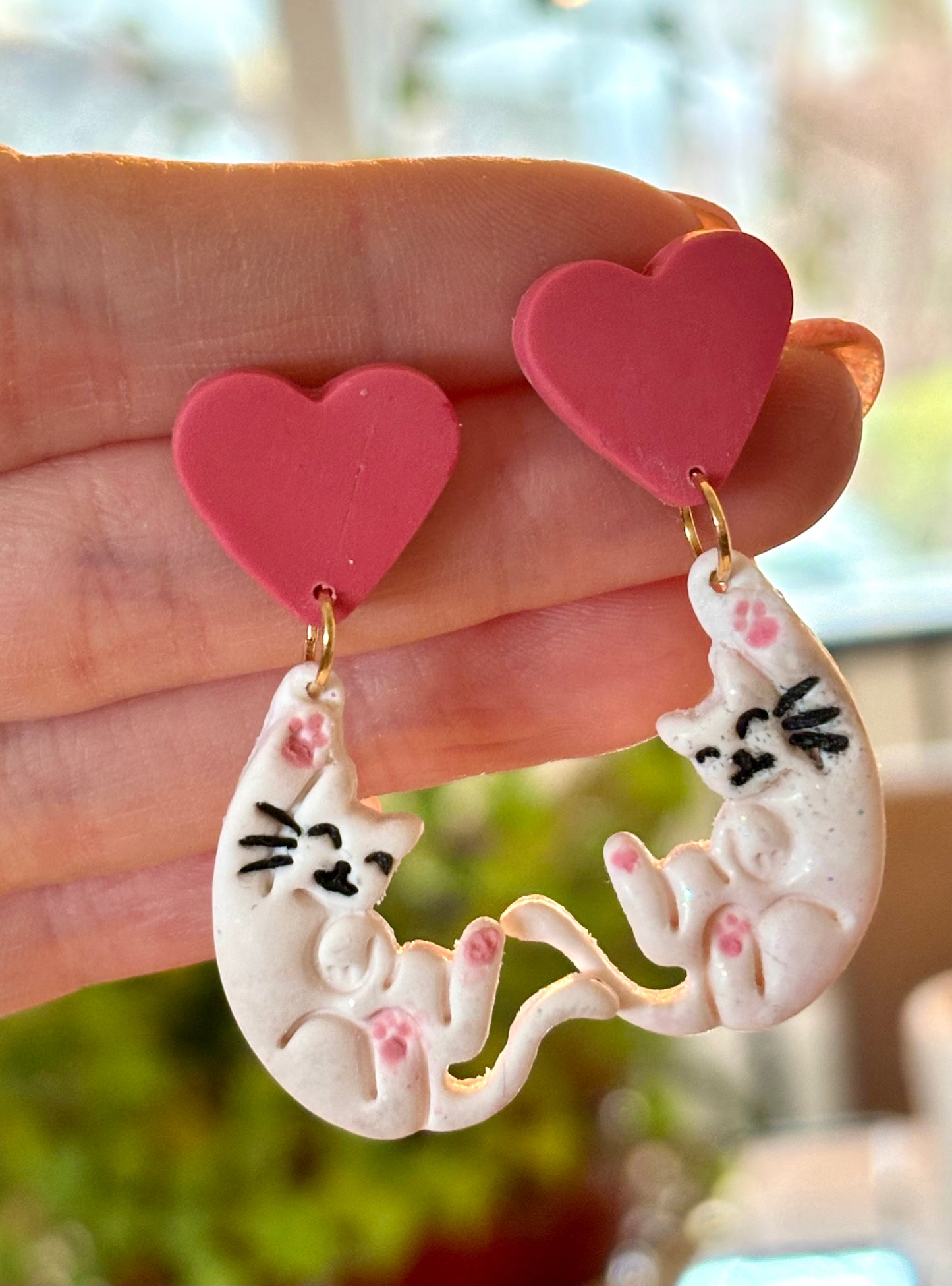 Hanging cats with hearts